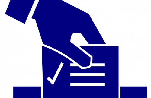 Ballot into ballot box with hand